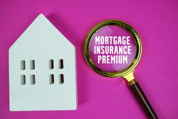 Mortgage Insurance Premium text with house model and magnifying glass on pink background