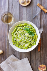 Pasta casarecce with pesto sauce, basil and cheese. Italian cuisine. Vegetarian food.