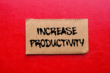 Increase productivity message written on ripped torn cardboard paper piece on red background. Conceptual increase productivity symbol. Copy space.