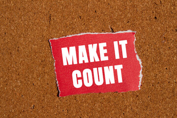 Make it count message written on ripped torn red paper piece on brown background. Conceptual make...
