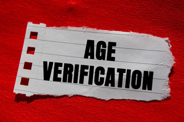 Age Verification message written on ripped torn lined paper piece on red background. Conceptual Age...