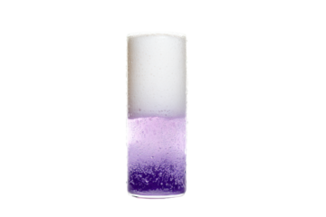 a tall glass filled with liquid and a purple substance