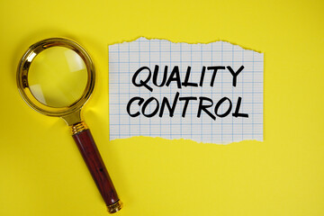 Quality Control text written on paper with magnifying glass