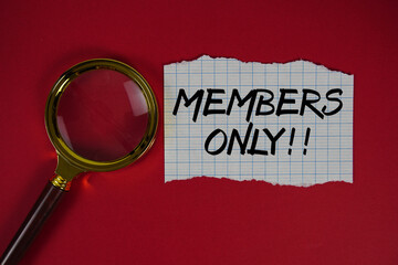 Members Only text written on paper with magnifying glass