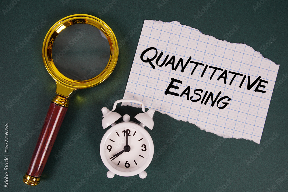 Poster quantitative easing text written on paper with magnifying glass and alarm clock