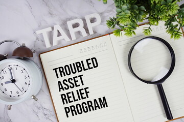 TARP - Troubled Asset Relief Program acronym on notepad, Business concept background