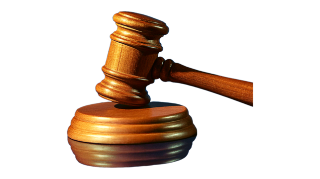 Wooden gavel rests on a round base symbolizing justice in a courtroom setting