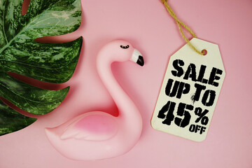 Price tag Sale 45% with summer decorations on pink background