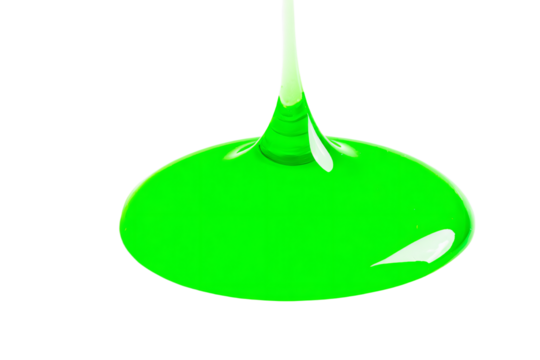 a green liquid is pouring into a glass
