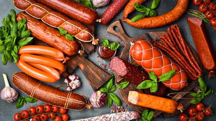 Different types of tasty sausages on grey table, flat lay
