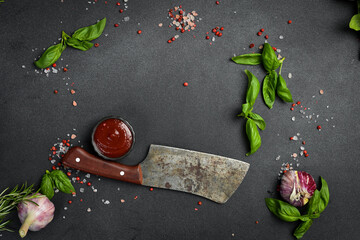 Cooking background. Top view. Kitchen knife, ketchup sauce, fresh basil and spices.