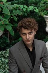 man in classic suit in the garden on the street