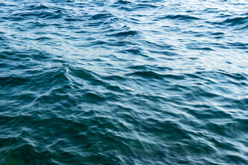 abstract close-up of sea water surface with ripples. subtle motion, clarity, and minimal fluid texture. calm water. minimalistic nature