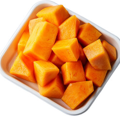 Cubed orange pumpkin pieces in a tray. Raw material.