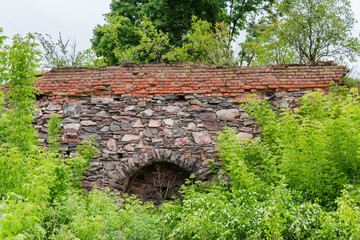 Fragment of defense stone-brick wall of ruined medieval castle