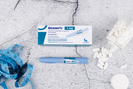 Semaglutide medication Ozempic with pen and tape on concrete, shown from above for medical, wellness and obesity concepts. In Barcelona - Spain. 12 July, 2025