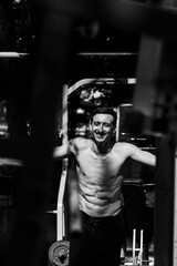Black and white photo of a man performing a parkour trick. Extreme sports photo.