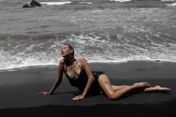 
Sexy girl on the ocean shore posing on the beach