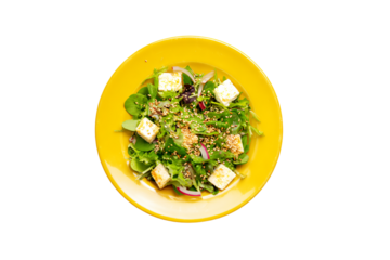 a yellow bowl filled with a salad and tofu