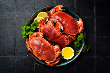 Crab. Three boiled red crabs on a plate, ready to eat. Close-up.