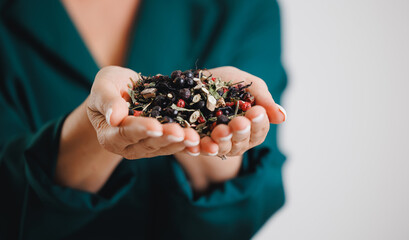 Female hands holding assorted herbal tea blend