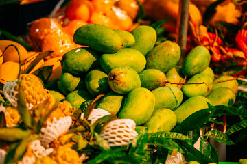 Fresh green mangoes at a vibrant Hanoi market stall display in Vietnam