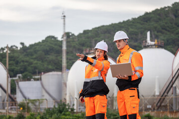 Team of Engineers Conducting Operations at Oil Storage Field Industrial Site, Engineers...