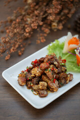 Fried pork belly with chili and salt or fried pork belly with chili and salt, Thai food. Pork belly is fried until crispy on the outside and soft on the inside. 