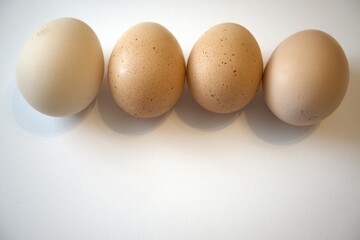 4 brown chicken eggs isolated with white background.