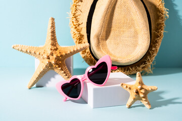 Sunglasses and sea shell with sunny shadows.