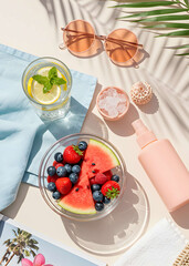 Summer picnic table, Summer flatlay with sunglasses, fruit bowl and refreshing drinks