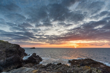 Beautiful vibrant Summer sunset landscape image of Pentire Headland in Cornwall England with dramatic sky