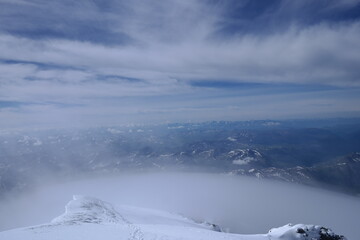 Tranquil Lake With Lush Green Forest, Snow-Capped Mountain, Blue Sky And White Clouds
