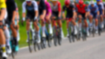 Intentionally blurred group of cyclists riding racing bikes during competitive road race