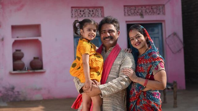 happy indian farmer with daughter and wife