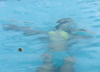 young girl s body drowned under the pool water with a swimsuit ideal as a photo for articles on...