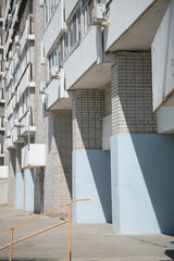 large brick blue plastered concrete arches on the ground floor of an apartment building