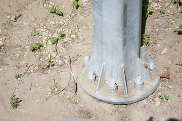  support of a metal lamppost reinforced with large iron screws