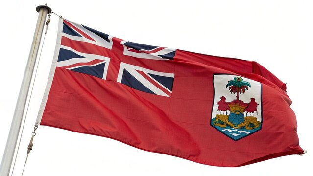 The bermuda flag flutters gracefully against a clear white sky, displaying its vibrant red ensign and british union jack