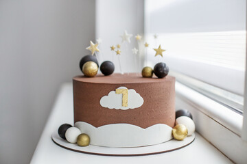 Modern chocolate birthday cake with stars and number one