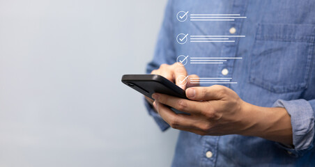 close up customer man hand use smartphone to check online questionnaire survey from website to rate...