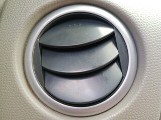 Surrounding  air vents is a circular frame in metallic gray or silver, which gives a modern and sleek look.