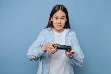 young woman with video game controller, embodying the excitement of gaming on light blue background