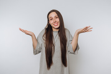 young woman with long hair shows a cheerful expression and raised arms, symbolizing joy and...