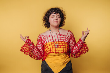 young woman practicing mindfulness through meditation in a colorful ensemble, reflecting a serene...