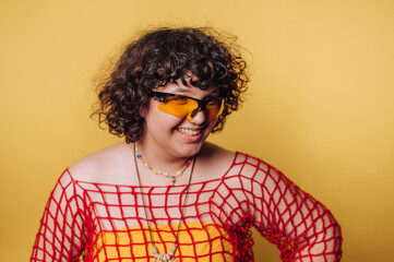 happy person with sunglasses and unique attire showcases joy and individuality on yellow background