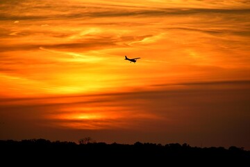 sunset in the sky showing a plane