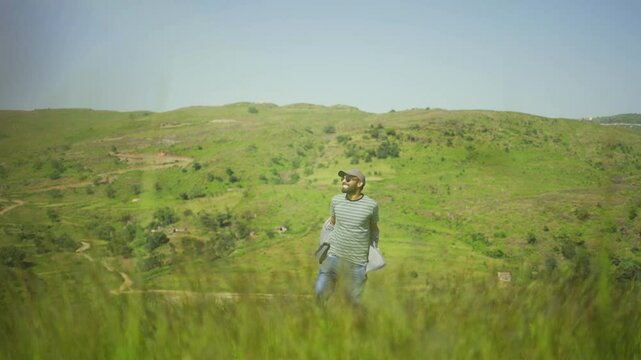 A man throwing a T-shirt in the meadows of Rayta Hills, nestled in the Aravalli Mountains near Udaipur, Rajasthan, India.