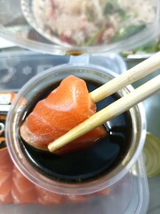 Sashimi in soy sauce and chopsticks. Japanese food.