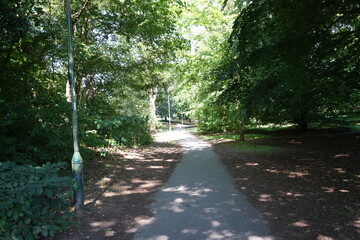 Tranquil woodland path with vintage lamp post at Bramcote Hills Park, Nottinghamshire, England.